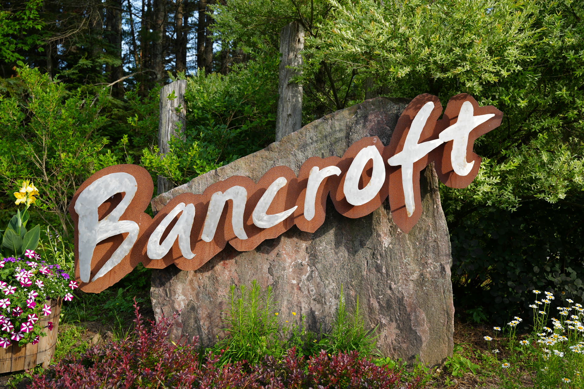 Bancroft town welcome sign with summer flower beds